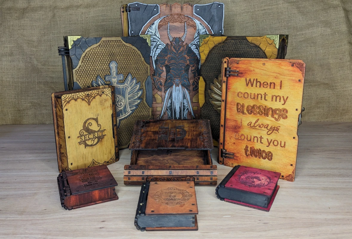 Assorted engraved wooden fantasy boxes and gaming accessories displayed together, handcrafted RPG gifts